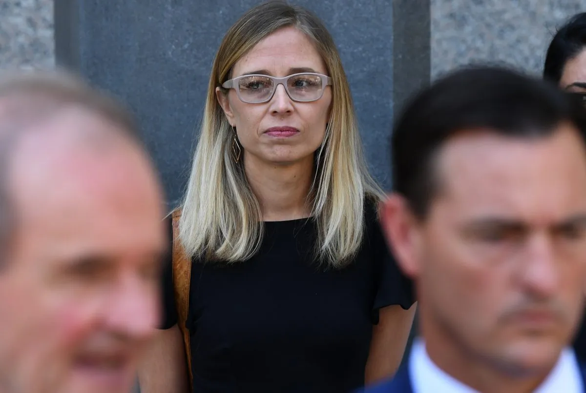 Annie Farmer, an alleged victim of convicted sex offender Jeffrey Epstein, stands behind lawyers at a press conference in New York City on July 15, 2019. (Timothy Clary/AFP/Getty Images)