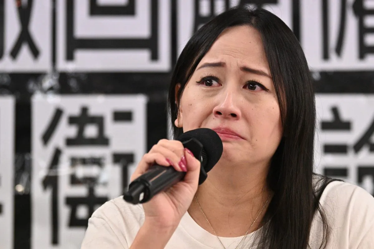 Hong Kong Dragon Airlines Flight Attendants Association chairperson Rebecca Sy, who was dismissed from her position as a flight attendant for Cathay Pacific's low-cost subsidiary Cathay Dragon, reacts during a press conference in Hong Kong on August 23, 2019. (ANTHONY WALLACE/AFP/Getty Images)