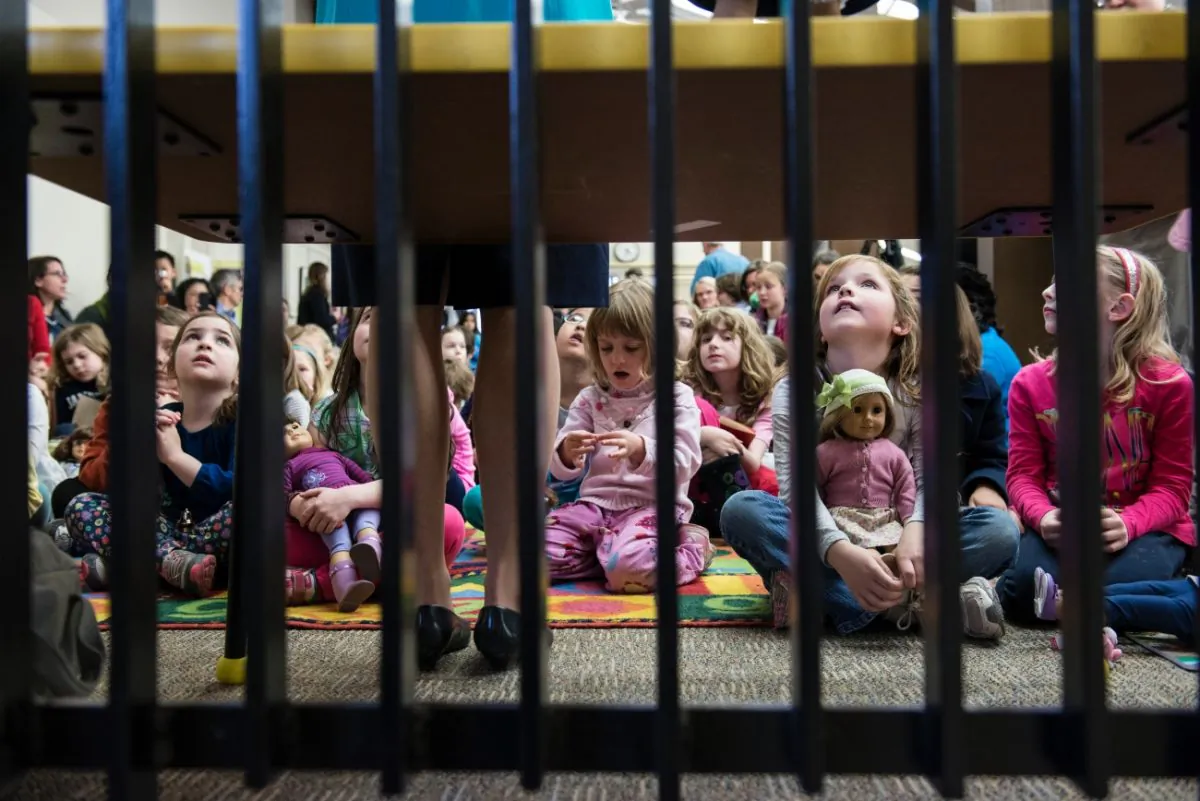 Children listen to a speaker at a library in Arlington, Virginia, on April 4, 2013. (BRENDAN SMIALOWSKI/AFP/Getty Images)