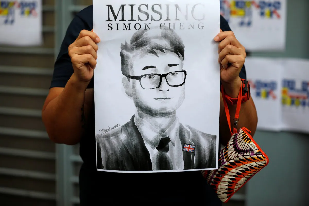 A woman holds a poster of Simon Cheng, a staff member at the British consulate who went missing on August 9 after visiting the neighbouring mainland city of Shenzhen, during a protest outside the British Consulate-general office in Hong Kong, China, on Aug. 21, 2019. (Reuters/Willy Kurniawan)