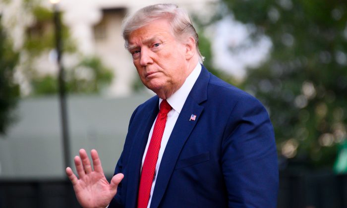 President Donald Trump waves as he arrives at the White House in Washington, on Aug. 21, 2019. (Jim WatsonAFP/Getty Images)