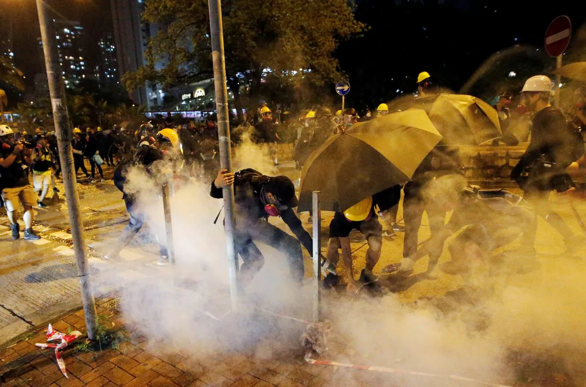 Anti-extradition bill protesters extinguish a tear gas cartridge during clashes with police near Wong Tai Sin station in Hong Kong, on Aug. 24, 2019. (Willy Kurniawan/Reuters)