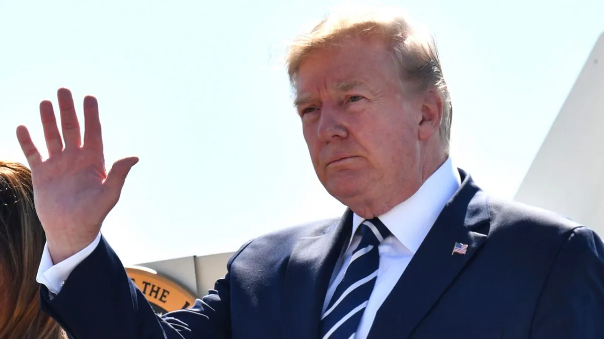 President Donald Trump waves as he and First Lady Melania Trump disembark an airplane in Biarritz, south-west France, on Aug. 24, 2019. (Nicholas Kamm/AFP/Getty Images)