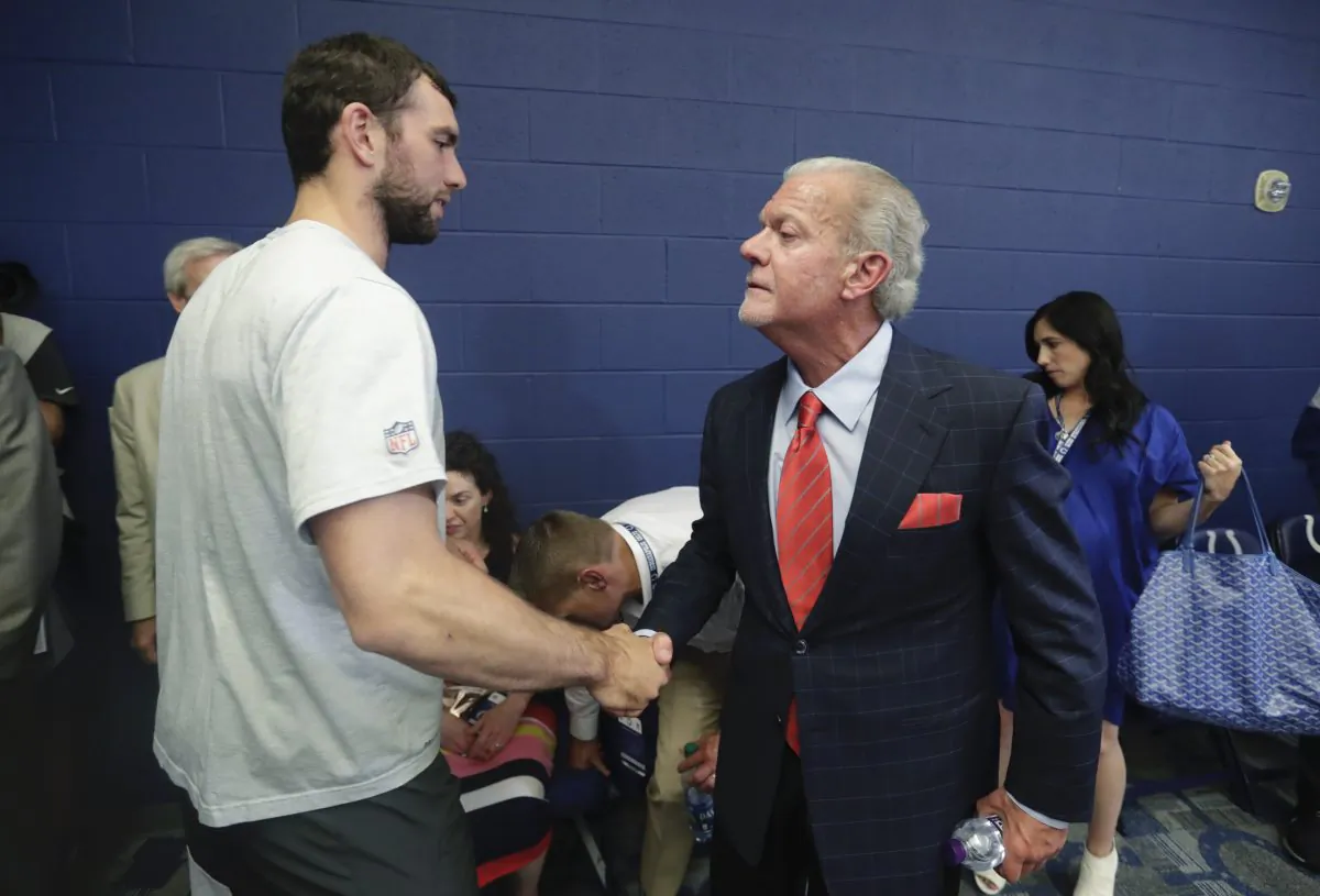 Indianapolis Colts quarterback Andrew Luck shakes hands with Colts owner Jim Irsay after a news conference following an NFL preseason football game against the Chicago Bears, in Indianapolis, on Aug. 24, 2019. (Michael Conroy/AP Photo)