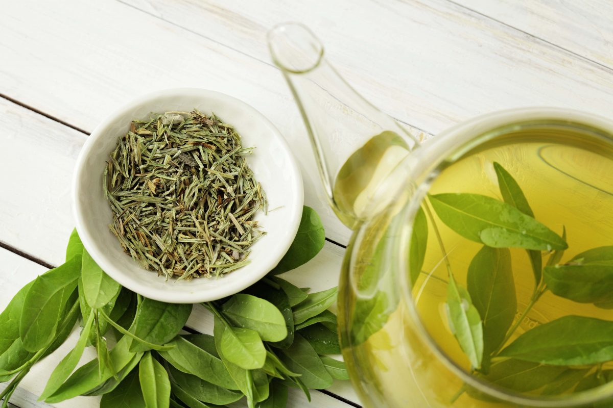 Green tea leaves in a pot and dried (KMNPhoto/Shutterstock)