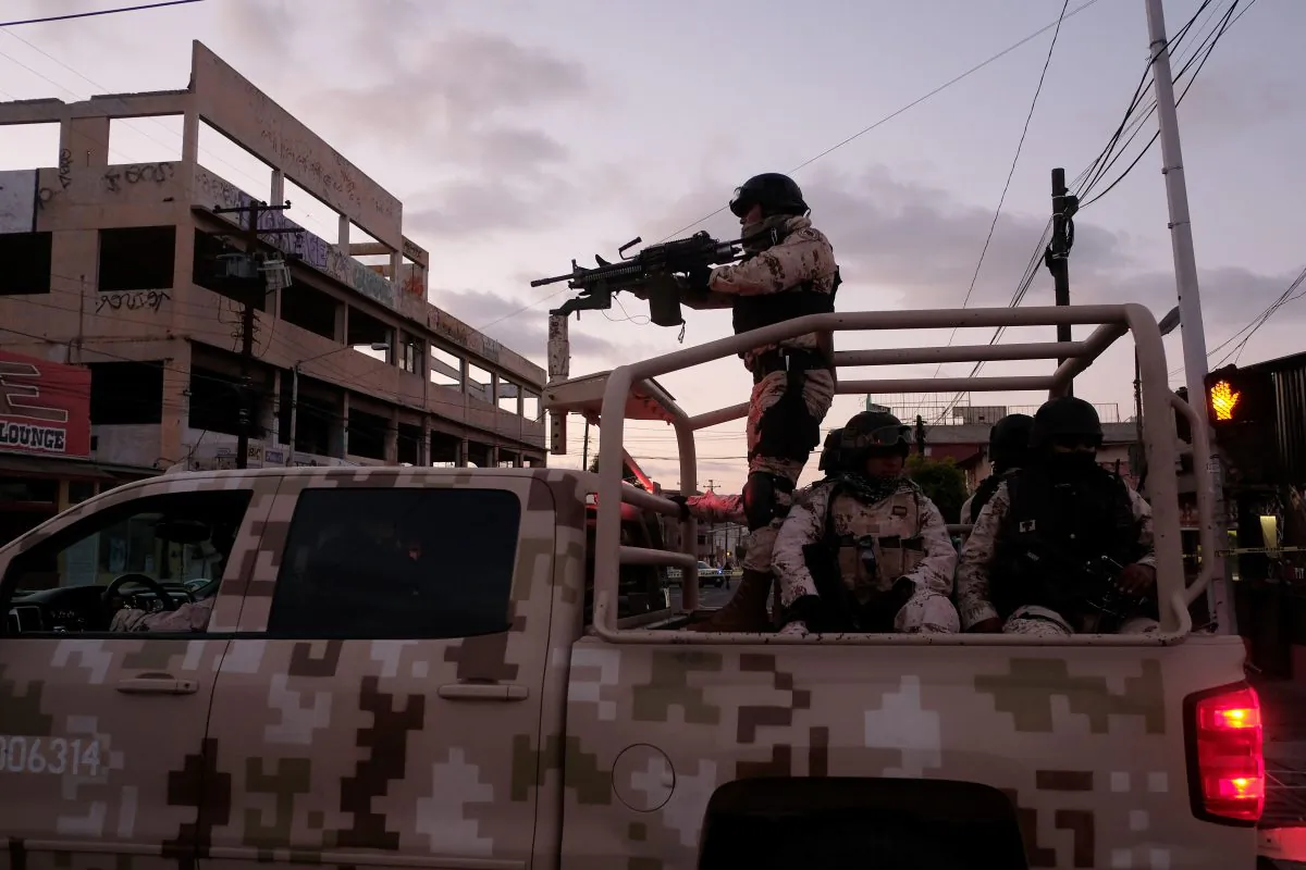Mexican soldiers leave the scene of a crime where a man was killed by suspected cartel gun fire in downtown Tijuana, Mexico, on April 21, 2019. (Guillermo Arias / AFP)