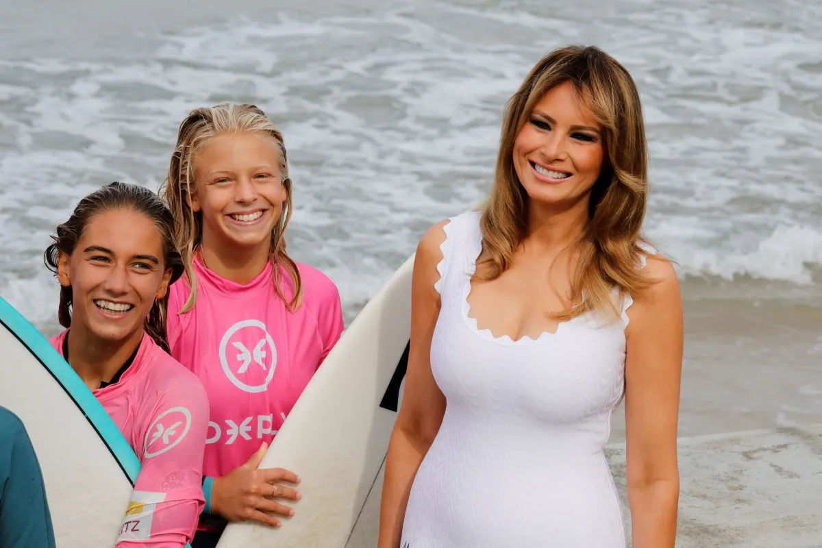 First Lady Melania Trump meets surfers as G7 leaders' spouses watch a surf class on the Cote des Basques beach in Biarritz on Aug. 26, 2019, on the third and last day of the annual G7 Summit attended by the leaders of the world's seven richest democracies, Britain, Canada, France, Germany, Italy, Japan and the United States. (THOMAS SAMSON/AFP/Getty Images)