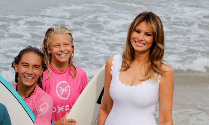 First Lady Melania Trump meets surfers as G7 leaders' spouses watch a surf class on the Cote des Basques beach in Biarritz on Aug. 26, 2019, on the third and last day of the annual G7 Summit attended by the leaders of the world's seven richest democracies, Britain, Canada, France, Germany, Italy, Japan and the United States. (THOMAS SAMSON/AFP/Getty Images)