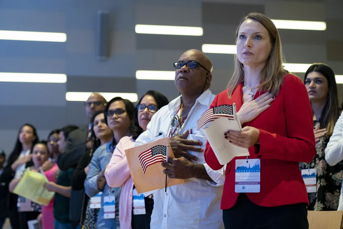 New U.S. citizens stand for the Pledge of Allegiance during a naturalization ceremony in New York City on July 2, 2019. (Drew Angerer/Getty Images)