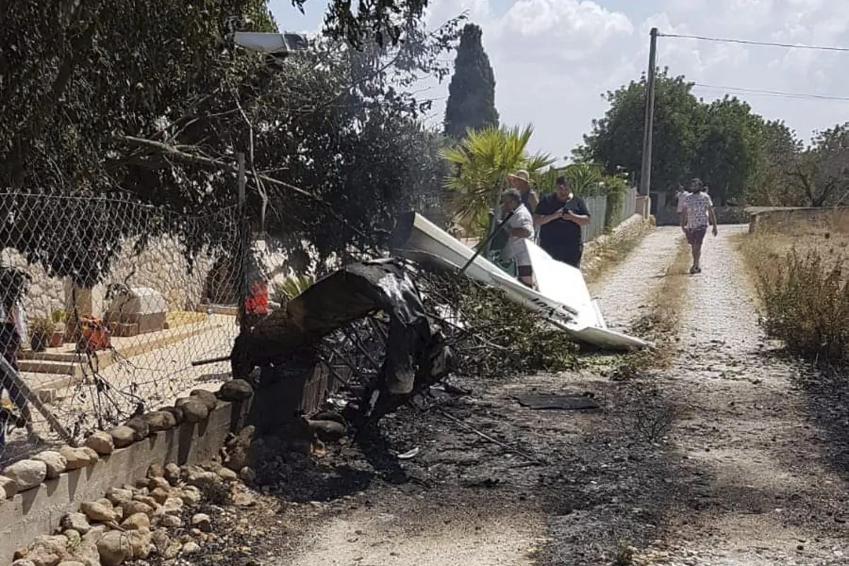 This photo provided by Incendios f.Baleares shows wreckage by a fence near Inca in Palma de Mallorca, Spain on Aug. 25, 2019. (Incendios f.Baleares via AP)