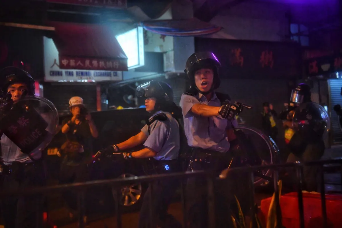 Police officers point their guns at protesters in Tseun Wan in Hong Kong on Aug. 25, 2019. (Lillian Suwanrumpha/AFP/Getty Images)
