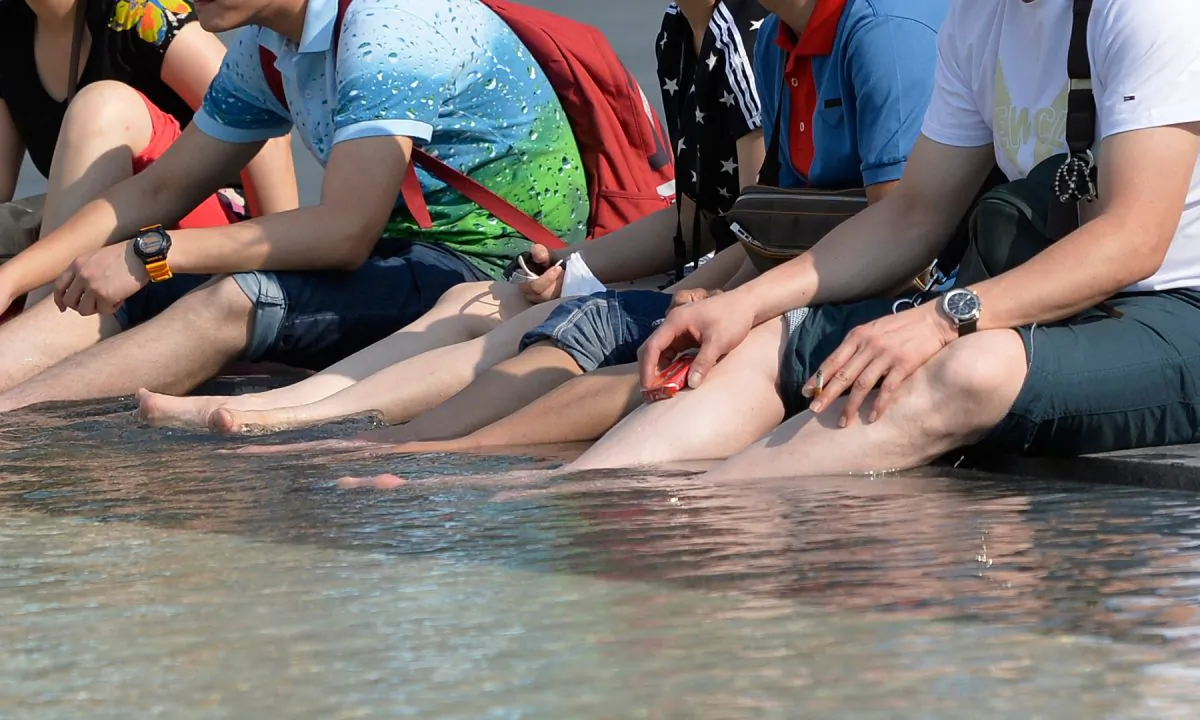 Individuals with their feet in a wading pool in this file photo. (Miguel Medina/AFP/Getty Images)
