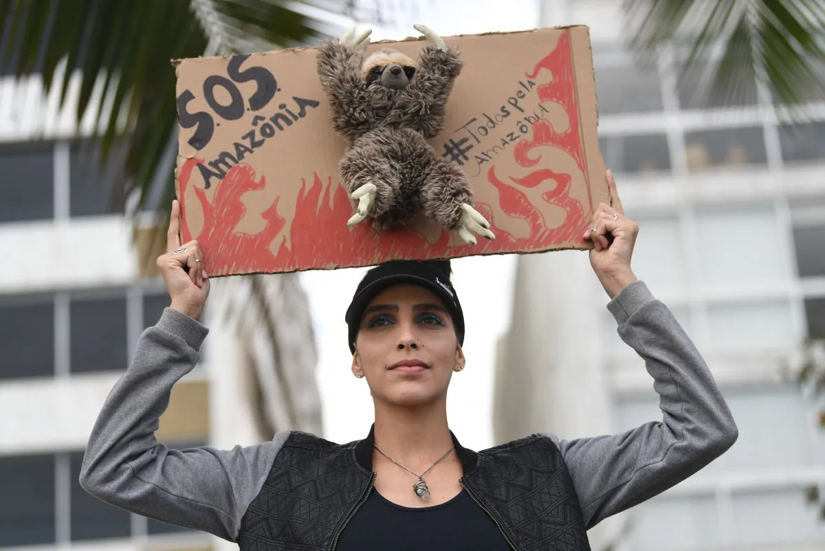 An activist demonstrates against the destruction of the Amazon rainforest, at Ipanema Beach in Rio de Janeiro, Brazil, on Aug. 25, 2019. (Mauro Pimentel/AFP/Getty Images)