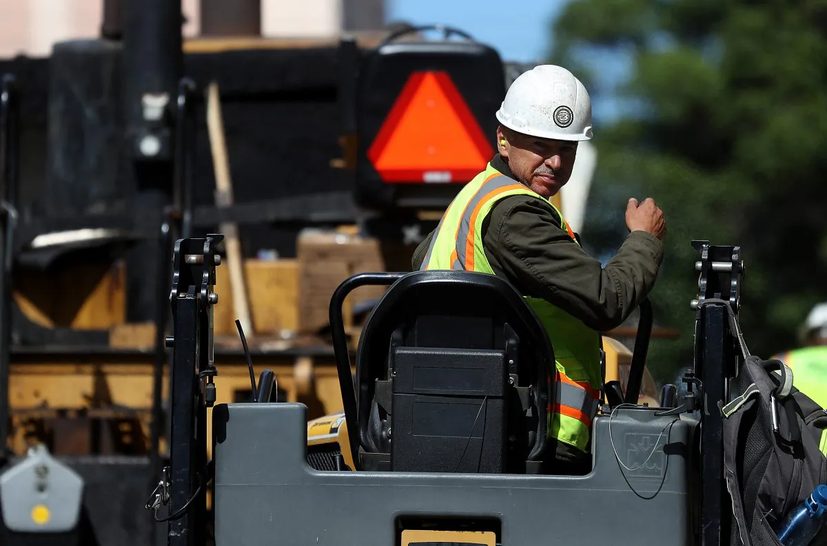 A construction worker operates a steam roller while paving a road in San Francisco, Calif. on Oct. 5, 2018. (Justin Sullivan/Getty Images)