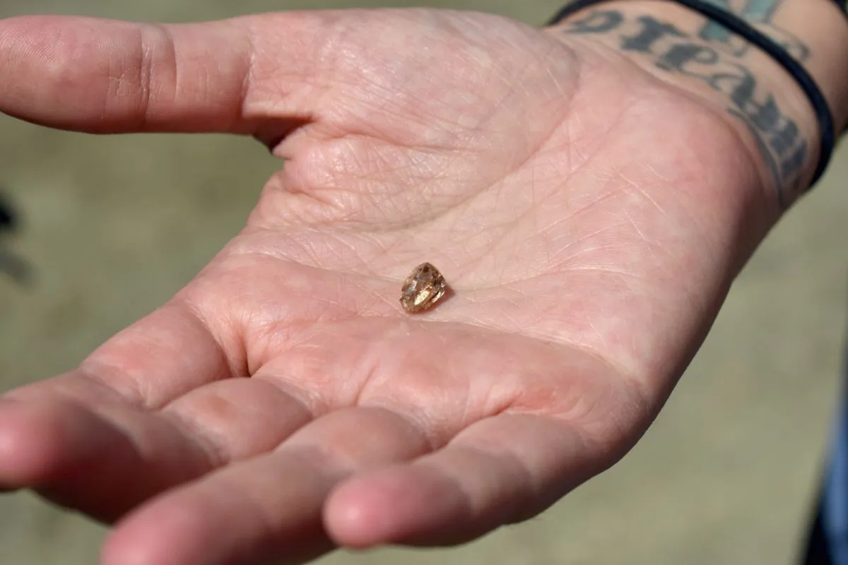 Miranda Hollingshead holds the yellow diamond she found in an Arkansas state park on Aug. 16, 2019. (Arkansas State Parks)