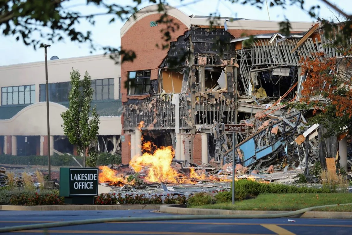 A damaged building and burning debris nearby after an explosion at an office complex and shopping center in Columbia, Md., on Aug. 25, 2019. (Howard County Fire And Rescue via AP)