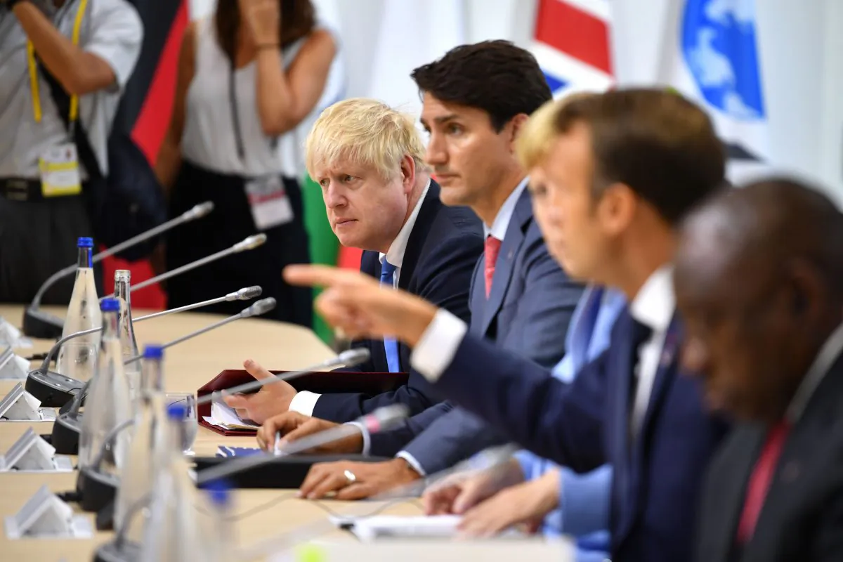 (L-R) British Prime Minister Boris Johnson, Canadian Prime Minister Justin Trudeau, German Chancellor Angela Merkel and French President Emmanuel Macron attend a working lunch during the G7 Summit in Biarritz, France, on Aug. 26, 2019. (Jeff J Mitchell/Getty Images)
