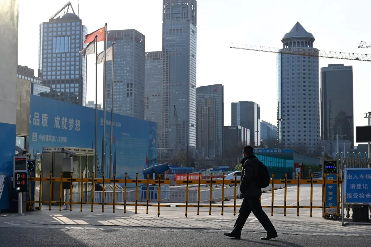 A man walks past the entrance to a construction site in Beijing on Feb. 11, 2019. (Greg Baker/AFP/Getty Images)