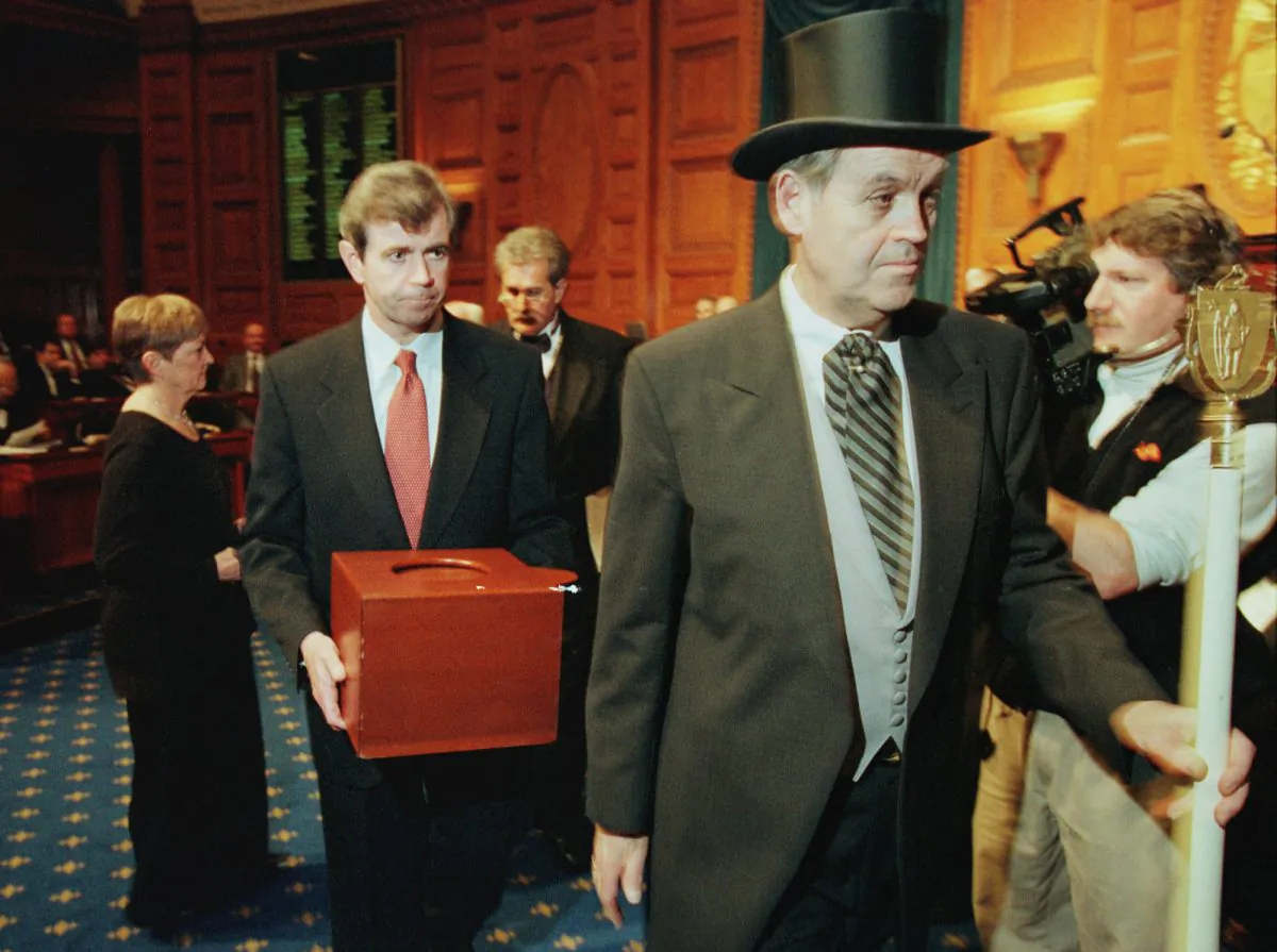 Massachusetts Secretary of the Commonwealth William Galvin, center, carries a ballot box containing the 12 Massachusetts electoral votes for Vice President Al Gore as he is led by Sergeant-at Arms Michael Rea, right, during the Electoral College voting at the Statehouse December 18, 2000 in Boston. Pool Photo/Getty Images