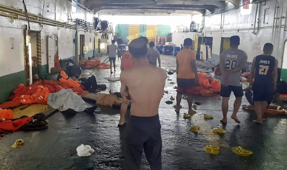 In this photo provided by Philippine Coast Guard in Manila, rescued passengers of the ill-fated M/V Lite Ferry 16, are attended to by the coast guard rescuers and crew of responding vessels, on a ferry which responded to the incident, following a ferry fire on Aug. 28, 2019, off Dapitan city in Zamboanga del Norte province in southern Philippines. (Philippine Coast Guard via AP)