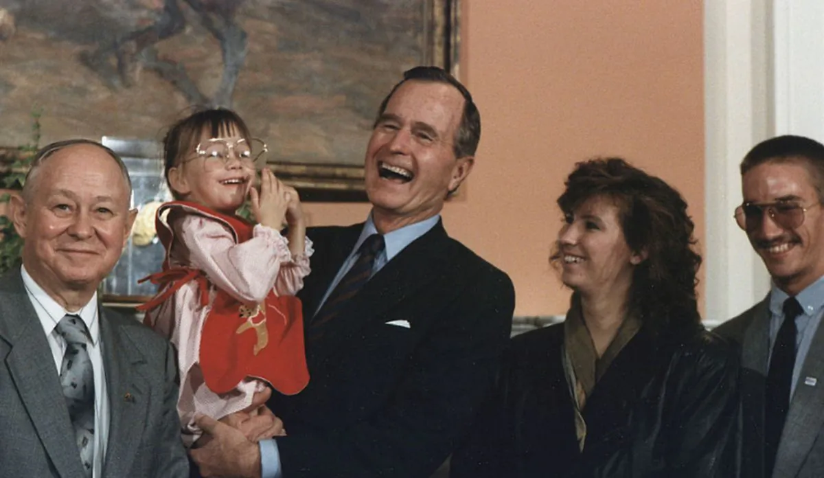 President Bush holds Jessica McClure during the Midland Community Spirit Award Presentation in the Roosevelt Room at the White House. The award was established by the town of Midland, TX and awarded to Sioux City, IA in recognition of the community's response to the crash of United Airlines Flight 232 on July 19, 1989 (Public Domain)