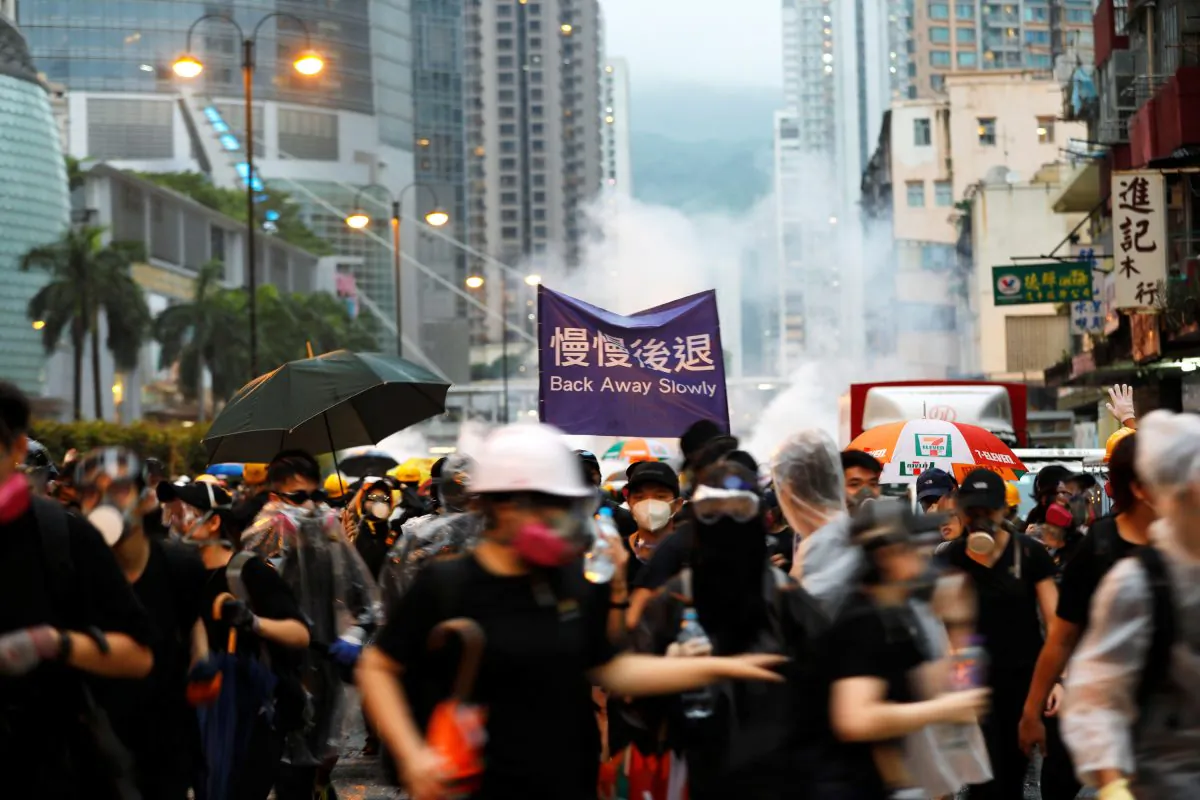 Anti-extradition bill protesters run as riot police fire tear gas during a protest in Hong Kong, China on Aug. 25, 2019. (Willy Kurniawan/Reuters)