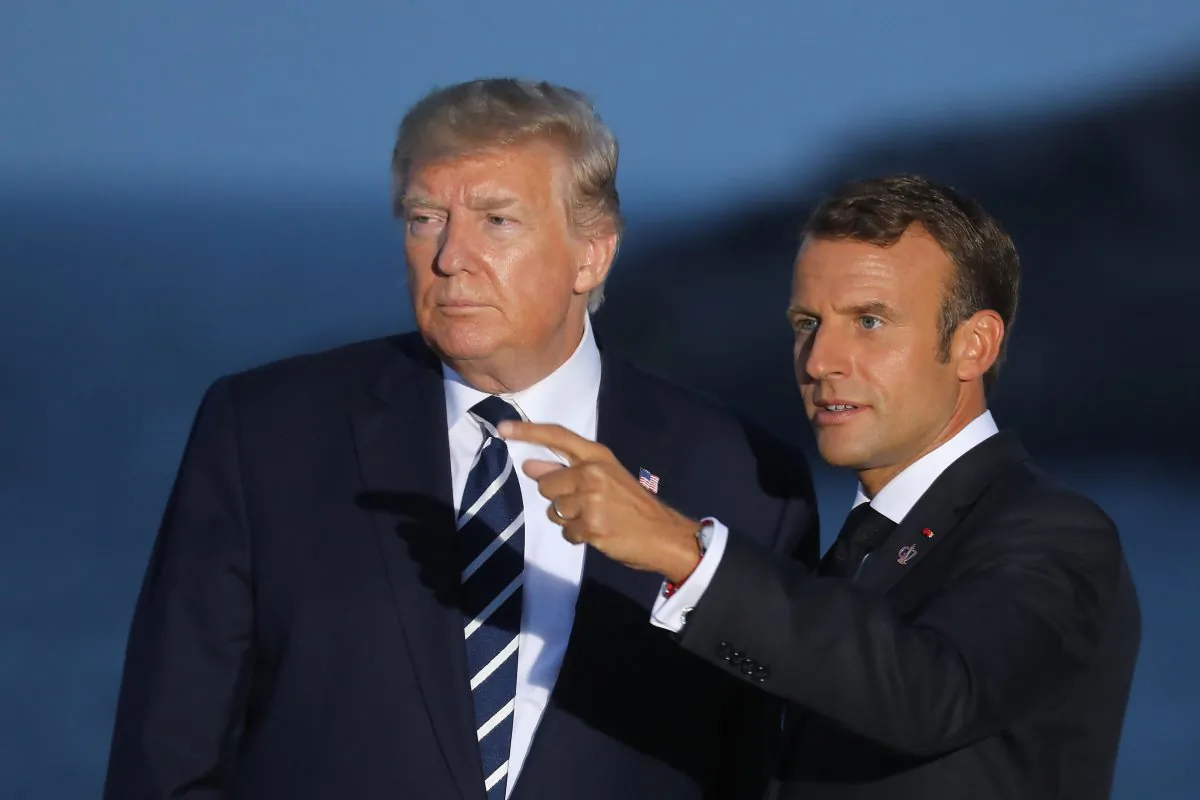 U.S. President Donald Trump (L) and France's President Emmanuel Macron gesture prior to a family picture with G7 leaders and guests, on the second day of the annual G7 summit in Biarritz, southwest France on Aug. 25, 2019. (Ludovic Marin/AFP/Getty Images)