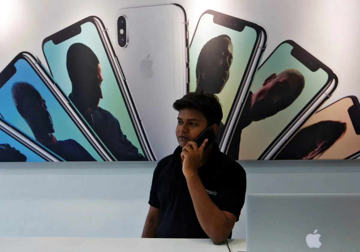 A salesperson speaks on the phone at an Apple reseller store in Mumbai, India on July 27, 2018. (Francis Mascarenhas/Reuters)