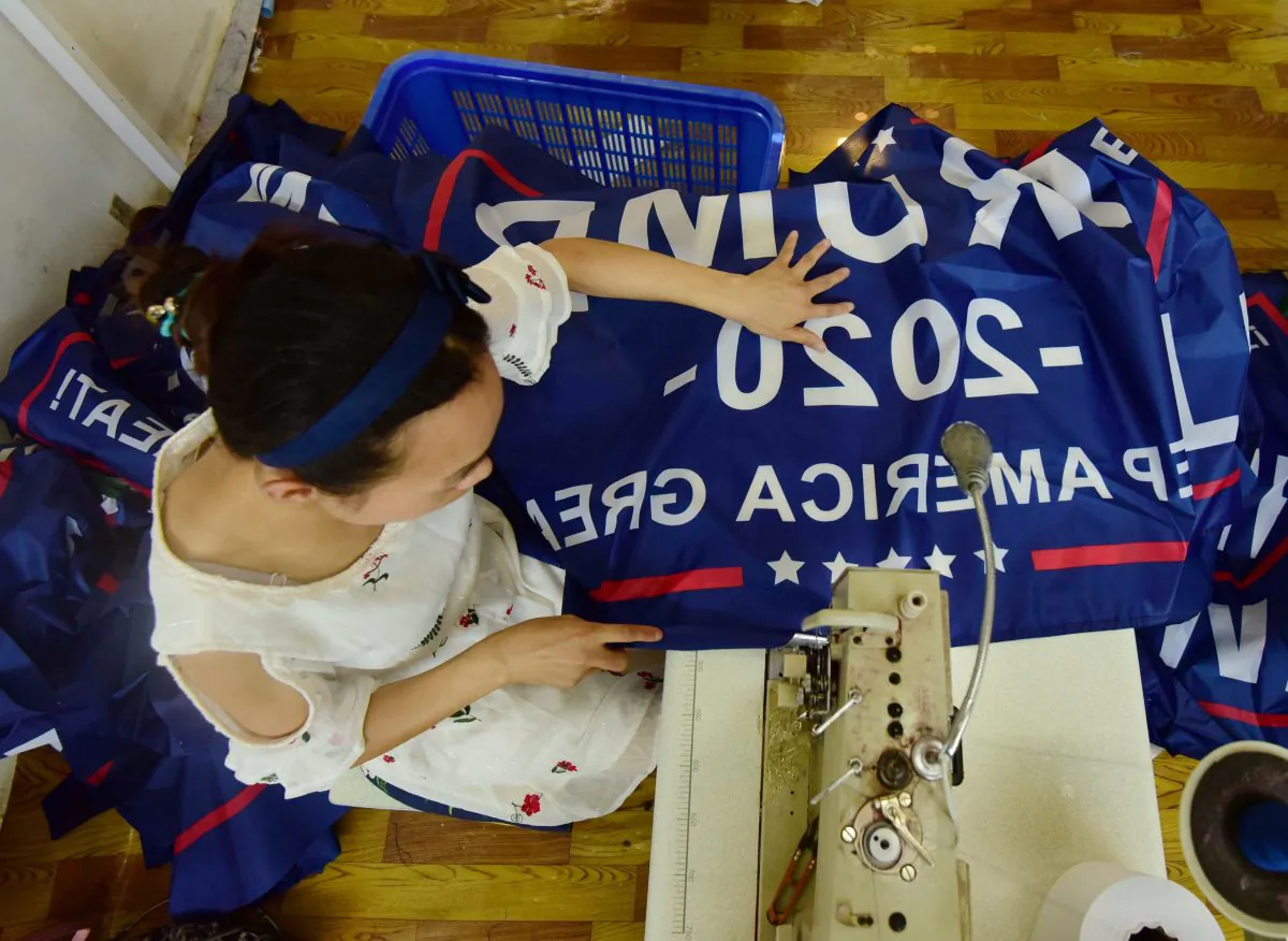 A Chinese worker sews a banner declaring President Donald Trump's re-election intentions that reads "Trump 2020: Keep America Great" at a factory in Fuyang, Anhui Province, China on July 13, 2018. (AFP/Getty Images)