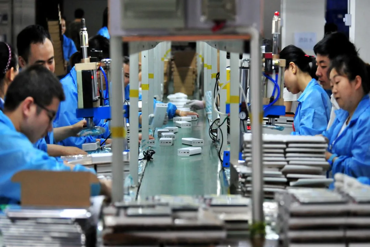 Employees work on a production line manufacturing lithium battery products at a factory in Yichang, Hubei Province, China, on May 28, 2019. (Reuters)