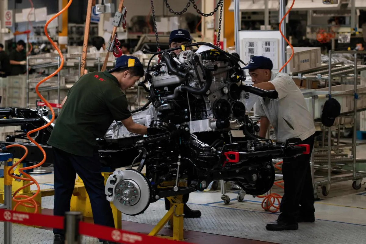 Workers on an SUV production line on the BAIC (Beijing Automotive Group Co.) in Beijing on Aug. 29, 2018. (NICOLAS ASFOURI/AFP/Getty Images)