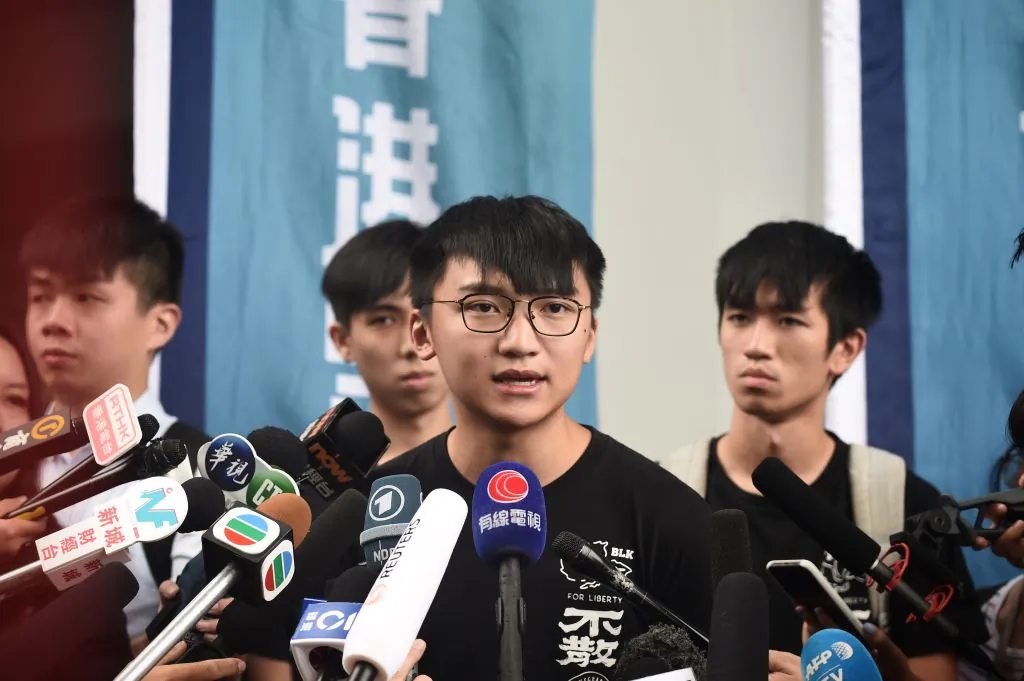 Demosisto vice-chairperson Isaac Cheng speaks to press on the arrest of Joshua Wong and Agnes Chow, in Hong Kong on Aug. 30, 2019. (Lillian Suwanrumpha/AFP/Getty Images)