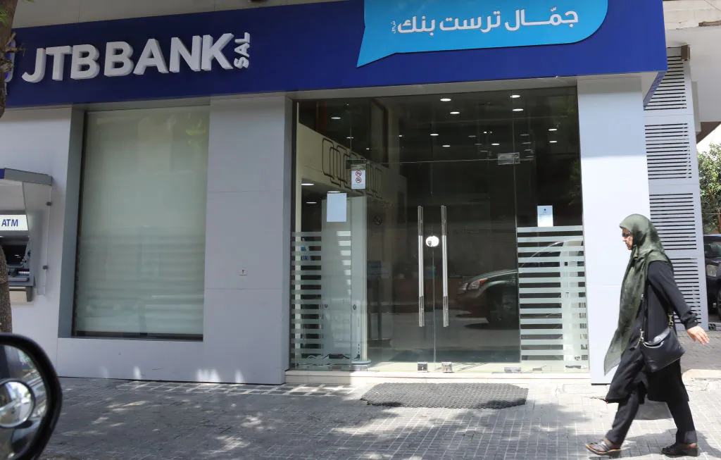 People walk past a branch of Jammal Trust Bank in the Beirut's Hamra street in the Lebanese capital on Aug. 30, 2019. (ANWAR AMRO/AFP/Getty Images)