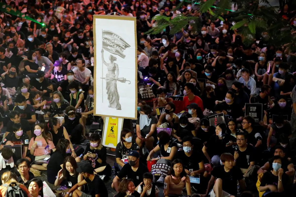 Protesters carry placards as they gather to condemn alleged sexual harassment of a detained demonstrator at a police station, in Hong Kong, China on Aug. 28, 2019. (Anushree Fadnavis/Reuters)
