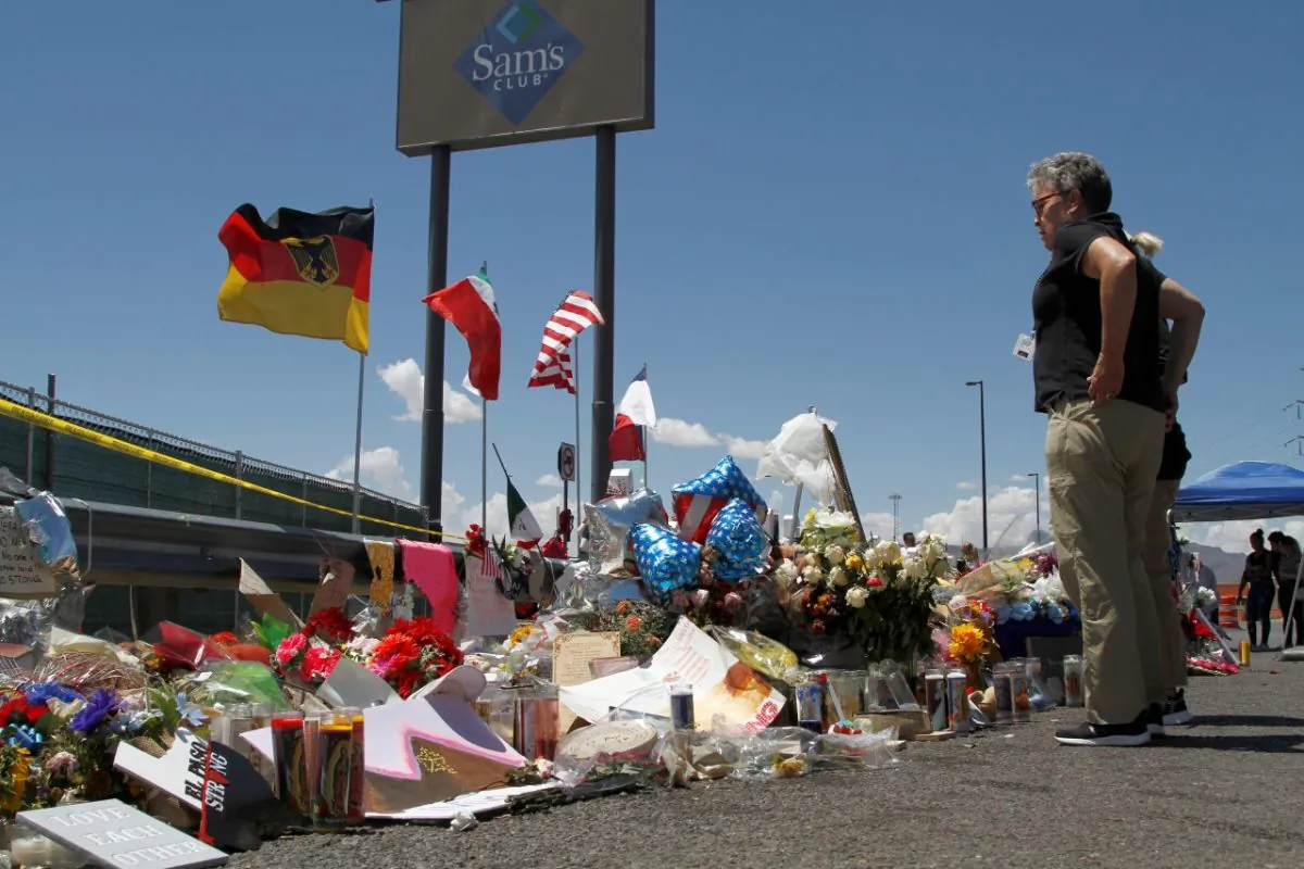Mourners visit the makeshift memorial near the Walmart where 22 people were killed in a mass shooting in El Paso, Texas, on Aug. 12, 2019. (Cedar Attanasio/AP Photo)