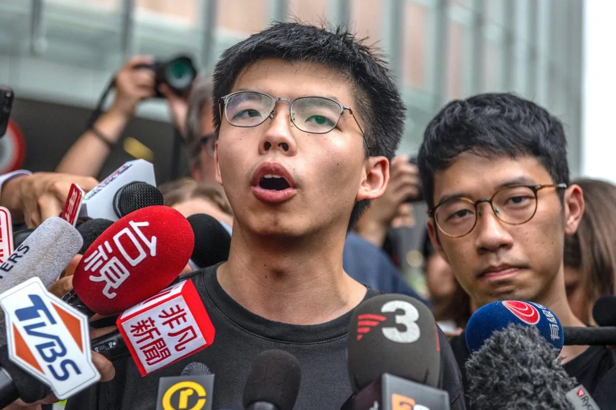 Pro-democracy activist Joshua Wong speaks to the media outside the Legislative Council shortly after being released from prison in Hong Kong, on June 17, 2019. (Carl Court/Getty Images)