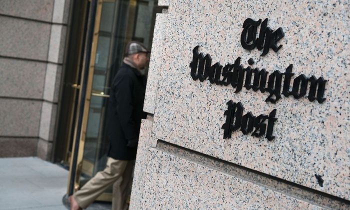 A man walks into the Washington Post's building in Washington on March 3, 2016. (Brendan Smialowski/AFP/Getty Images)