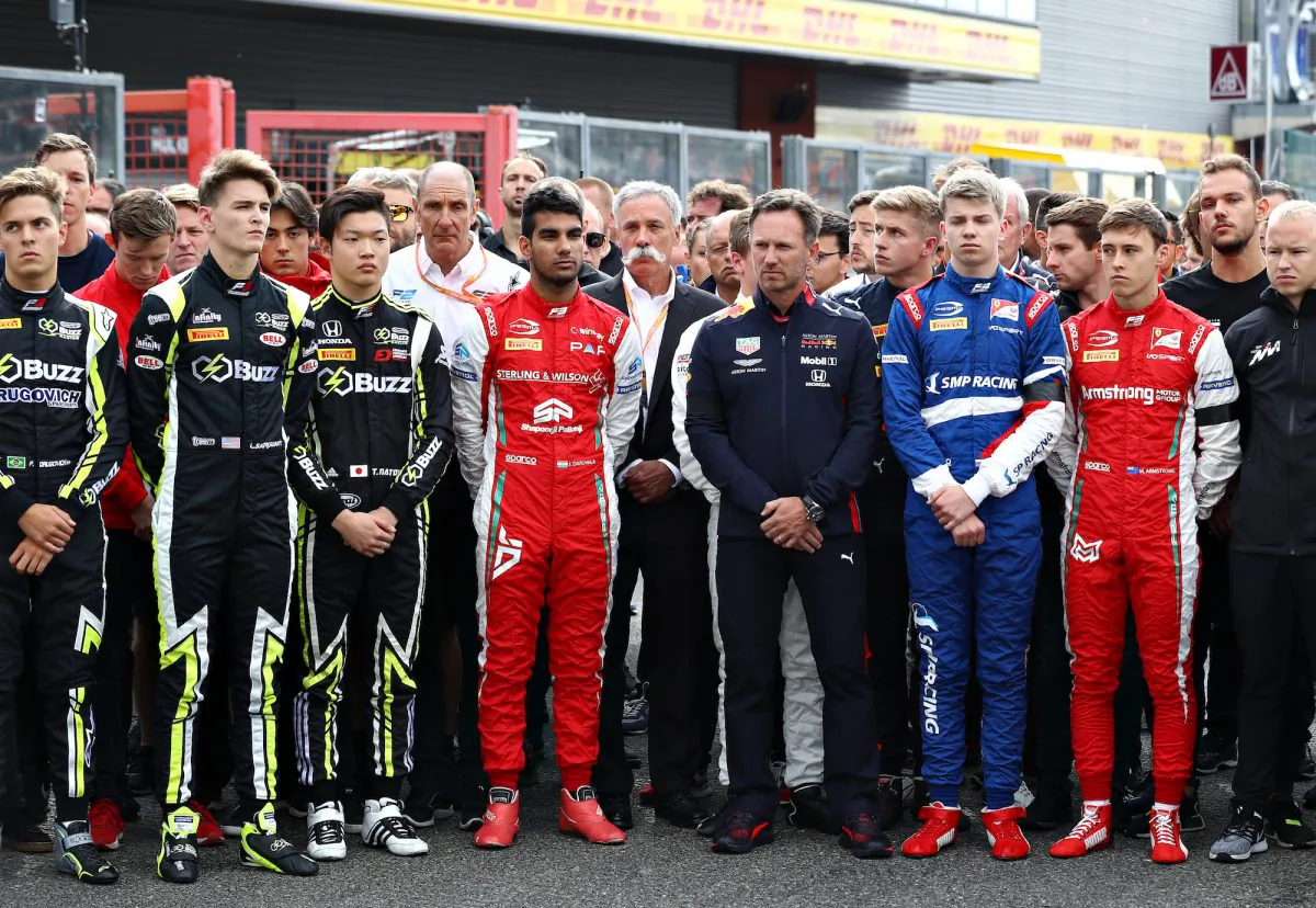 Members of the Formula 1, Formula 2, and Formula 3 communities observe a minute of silence in tribute to Anthoine Hubert at Circuit de Spa-Francorchamps in Spa, Belgium, on Sept. 1, 2019. (Mark Thompson/Getty Images)