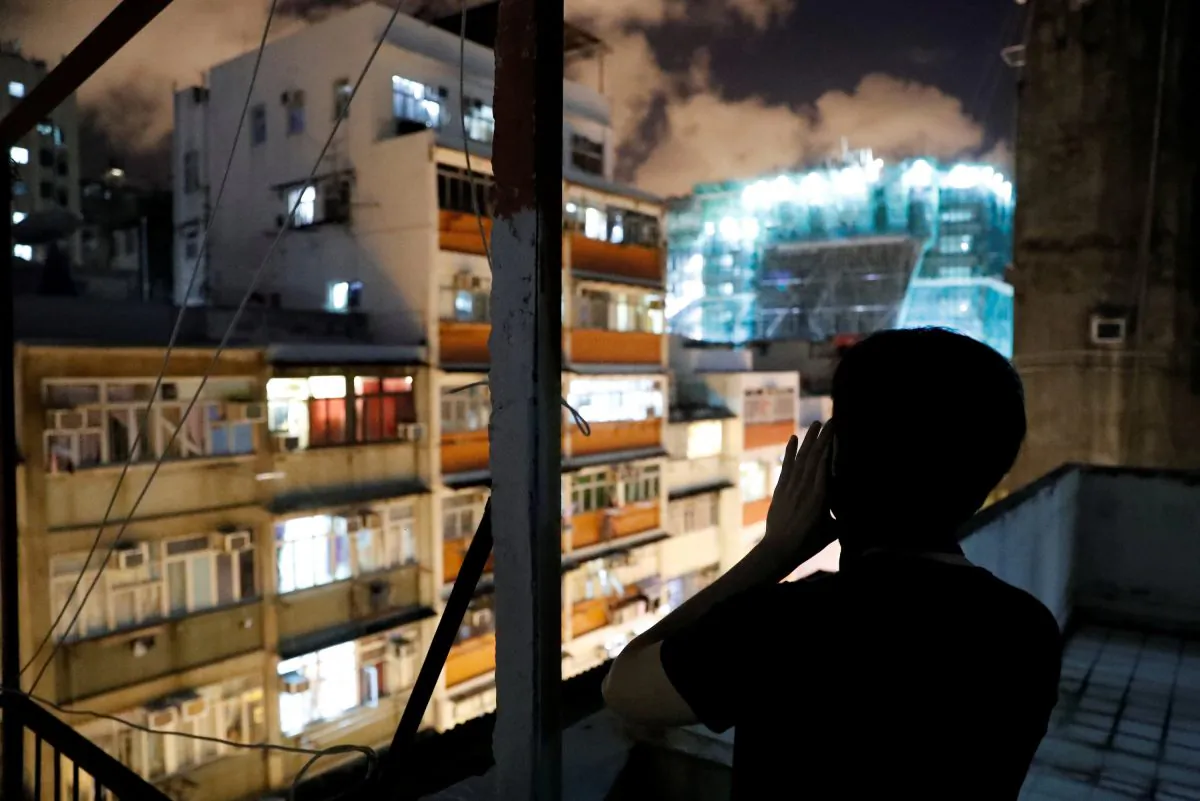 Choco Chu, 23, shouts slogan from his rooftop at Sham Shui Po in Hong Kong, China on Aug. 29, 2019. (Tyrone Siu/Reuters)