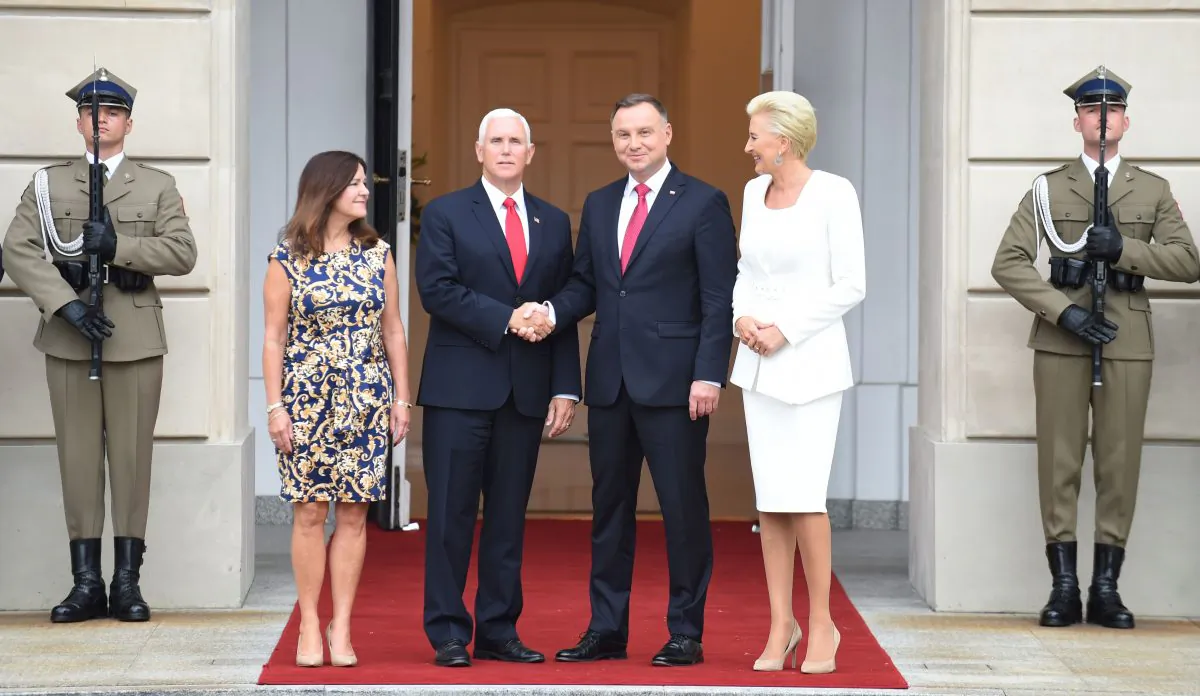 Polish President Andrzej Duda (2nd R) and US Vice President Mike Pence (2nd L) shake hands as their wives Agata Kornhauser-Duda (R) and Karen Pence (L) look on at the presidential palace in Warsaw on Sept. 2, 2019. (JANEK SKARZYNSKI/AFP/Getty Images)