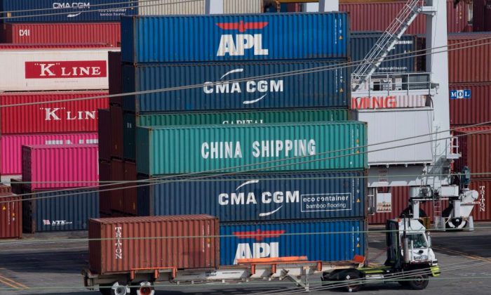 A truck passes by shipping containers at the Port of Los Angeles, after tariffs on Chinese imports was imposed by President Donald Trump, in Long Beach, California on Sept. 1, 2019. (Mark Ralston/AFP/Getty Images)