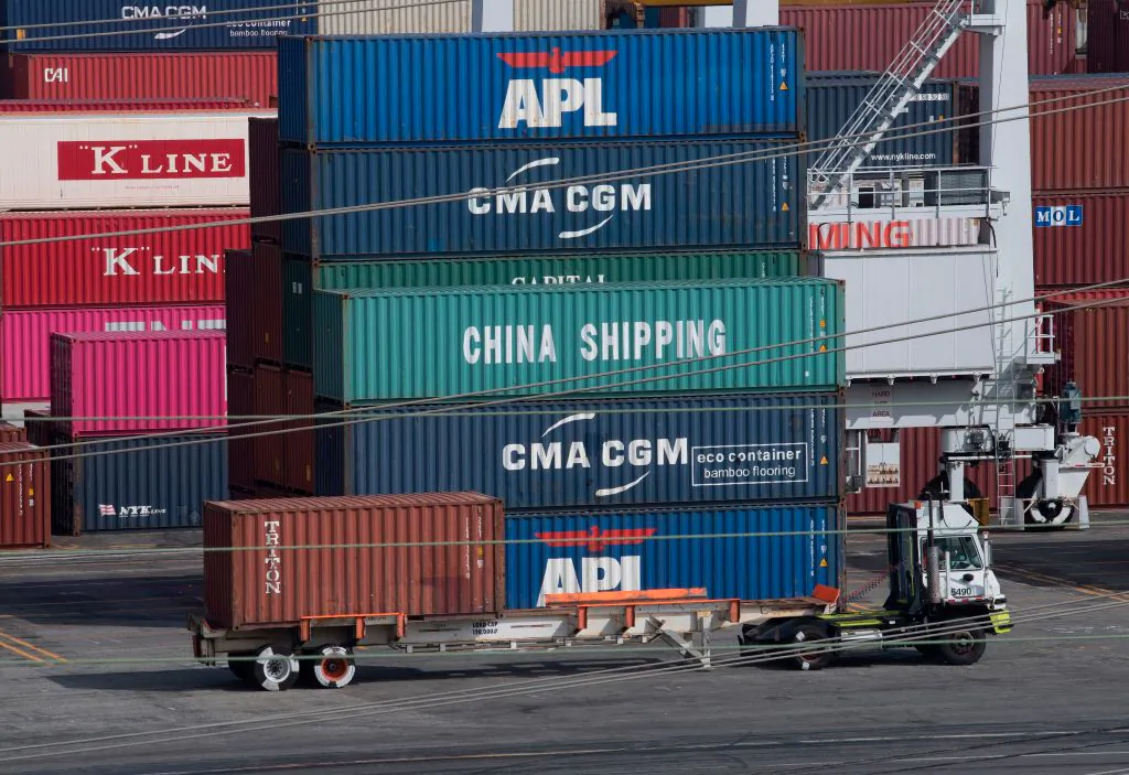 A truck passes by shipping containers at the Port of Los Angeles, after tariffs on Chinese imports was imposed by President Donald Trump, in Long Beach, California on Sept. 1, 2019. (Mark Ralston/AFP/Getty Images)