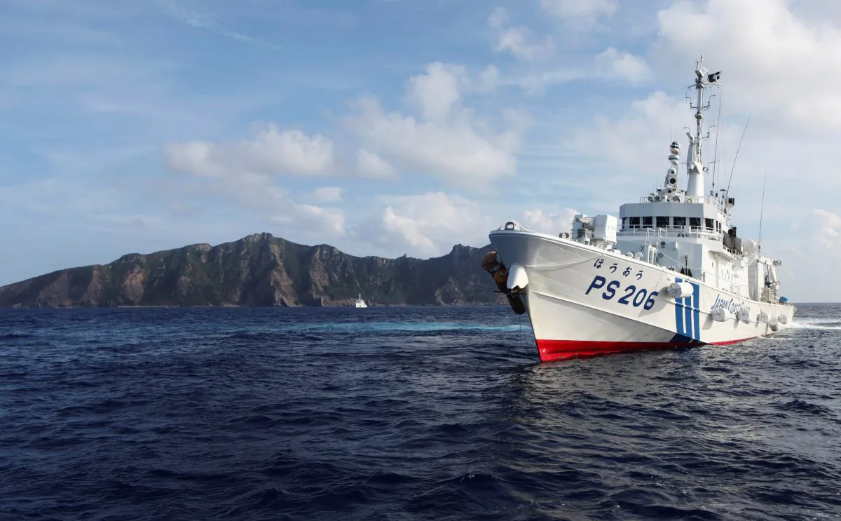 Japan Coast Guard vessel PS206 Houou sails in front of Uotsuri island, one of the disputed islands, called Senkaku in Japan and Diaoyu in China, in the East China Sea on Aug. 18, 2013. (Ruairidh Villar/Reuters)