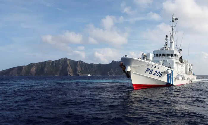 Japan Coast Guard vessel PS206 Houou sails in front of Uotsuri island, one of the disputed islands, called Senkaku in Japan and Diaoyu in China, in the East China Sea on Aug. 18, 2013. (Ruairidh Villar/Reuters)