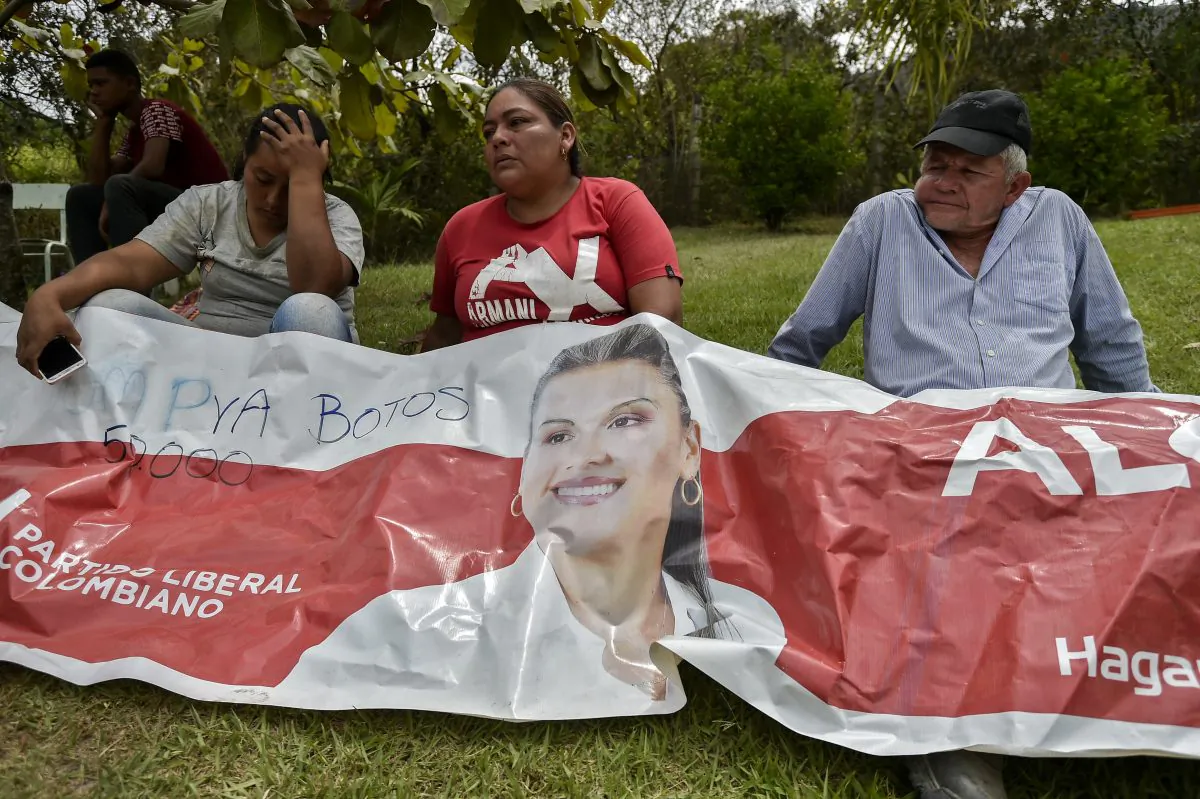 Relatives and friends of murdered mayoral candidate Karina Garcia mourn over a banner advertising her campaign in Suarez, Cauca, Colombia, on Sept. 2, 2019.  (Luis Robayo/AFP/Getty Images)