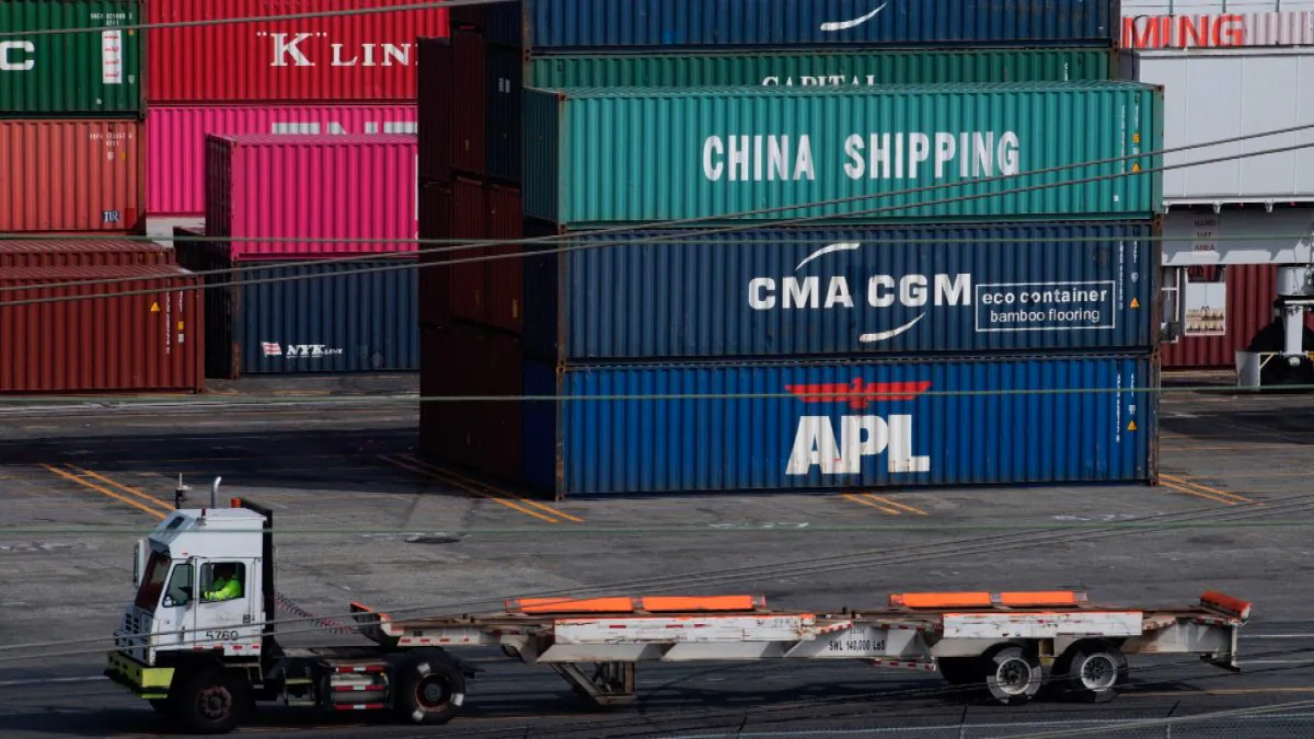 A truck passes by shipping containers at the Port of L.A., in Long Beach, Calif., on Sept. 1, 2019. (Mark Ralston/AFP/File Photo via Getty Images)