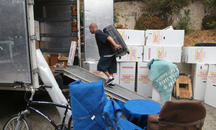 A worker moves a piece of furniture into a truck while moving a family in Tiburon, Calif., on Aug. 3, 2010. (Justin Sullivan/Getty Images)