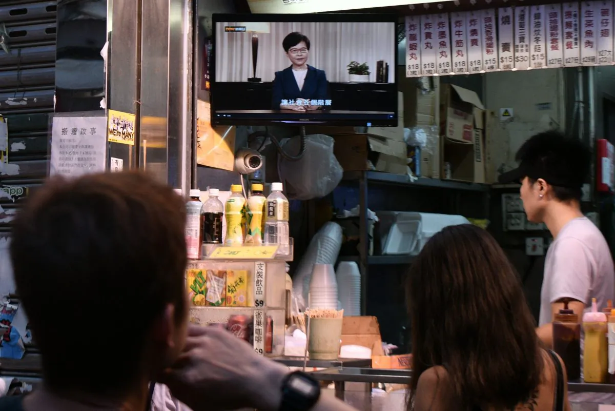 Customers at an eatery watch a live television broadcast showing Hong Kong Chief Executive Carrie Lam formally withdrawing a controversial extradition bill in Hong Kong on September 4, 2019. (ANTHONY WALLACE/AFP/Getty Images)