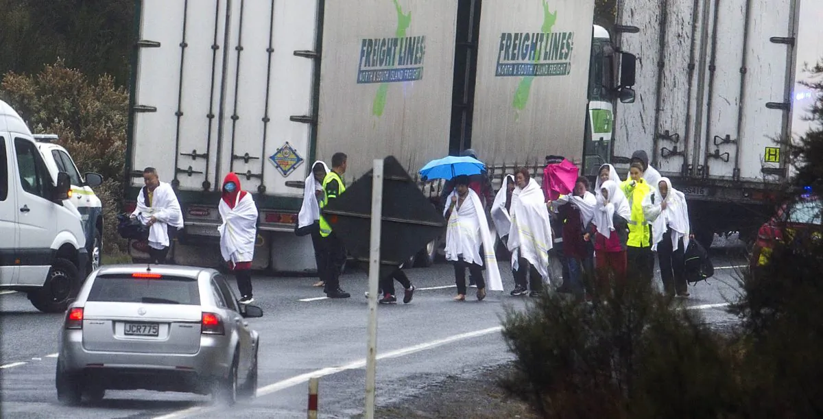 Survivors from a tourist bus crash walk along the highway in the Mamaku Ranges near Rotorua, New Zealand  onSept. 4. 2019. A bus carrying a group of Chinese tourists crashed near a popular New Zealand tourist town. (Ben Fraser/Rotorua Daily Post via AP)