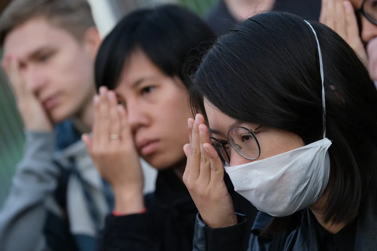 Protesters standing outside the Chancellery cover one eye in reference to an injured demonstrator in Hong Kong as they urge German Chancellor Angela Merkel to show solidarity with pro-democracy demonstrations in Hong Kong on Sept. 5, 2019, in Berlin, Germany. (Sean Gallup/Getty Images)